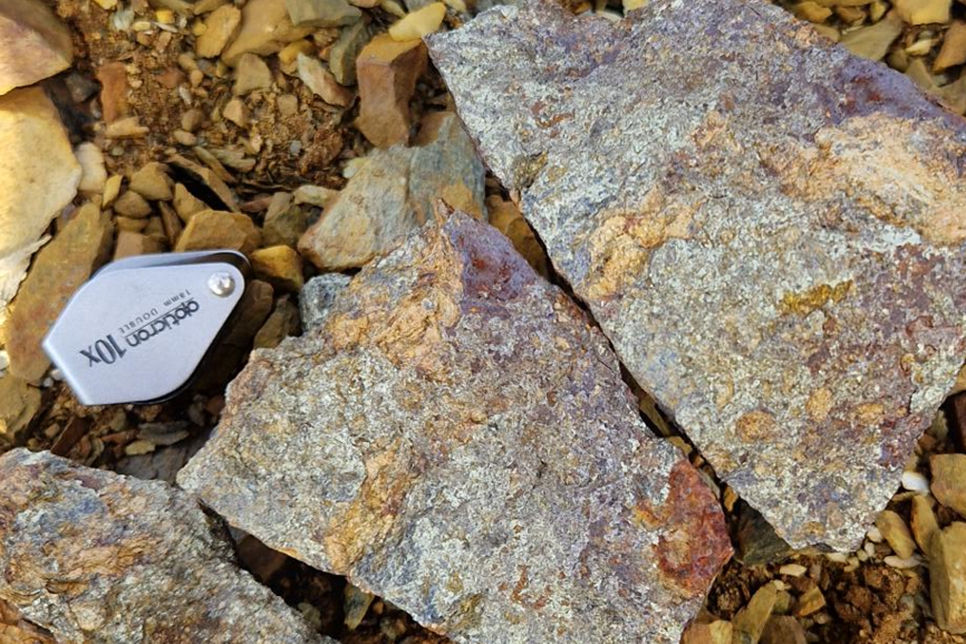 Photo 6: Sample D125056, Rock-chip sample taken from a dump in the Birtavarre area, containing 10.52% Cu. Brecciated massive sulphide containing chalcopyrite>>pyrrhotite.